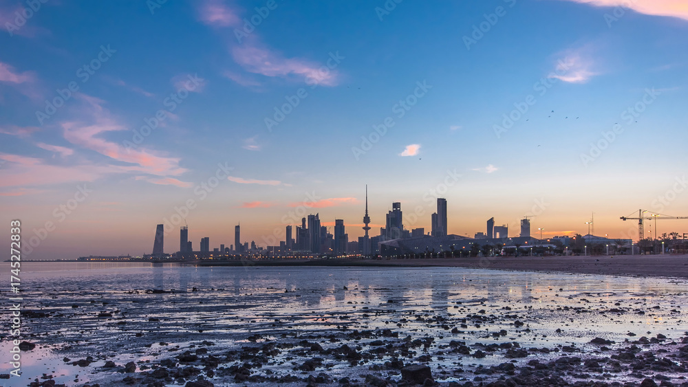Obraz premium Seaside skyline of Kuwait city from night to day timelapse