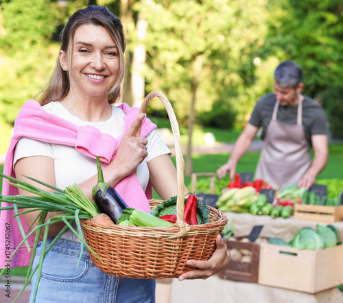 Canvastavla Woman with different fresh vegetables in wicker basket at farmer's market, selec