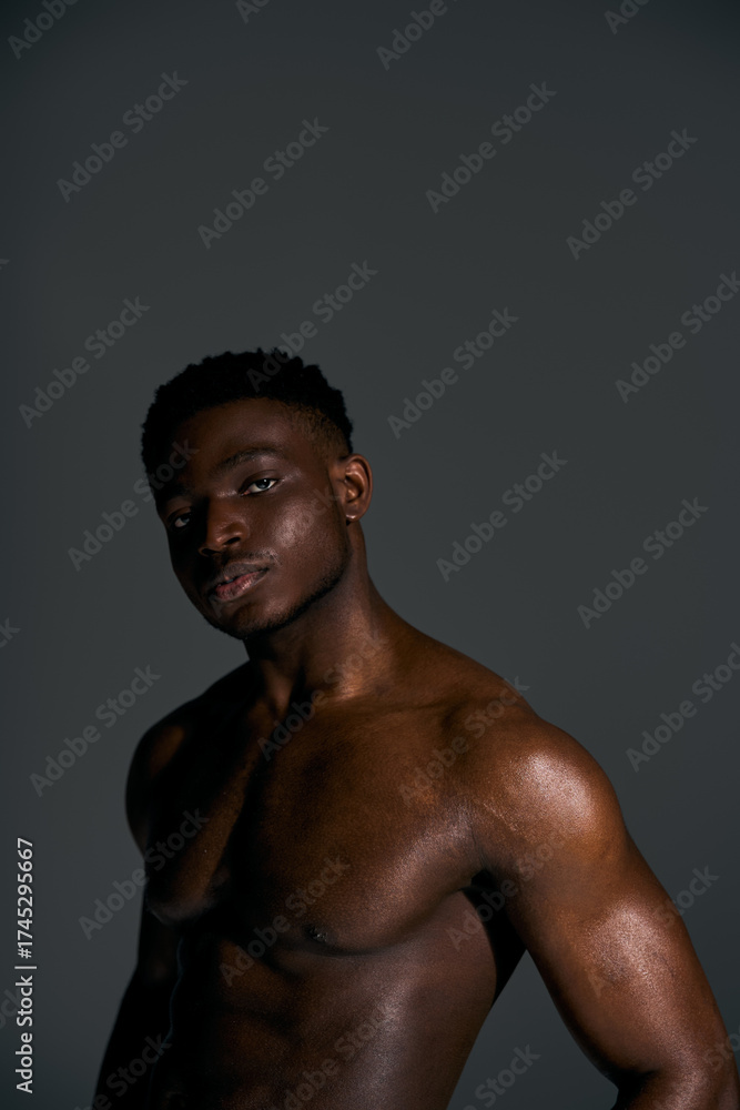 Fototapeta premium Muscular African American man posing confidently in a studio setting
