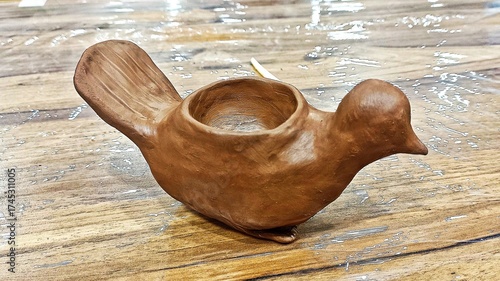Pottery Class/Workshop: Hands working with clay on a wooden table.