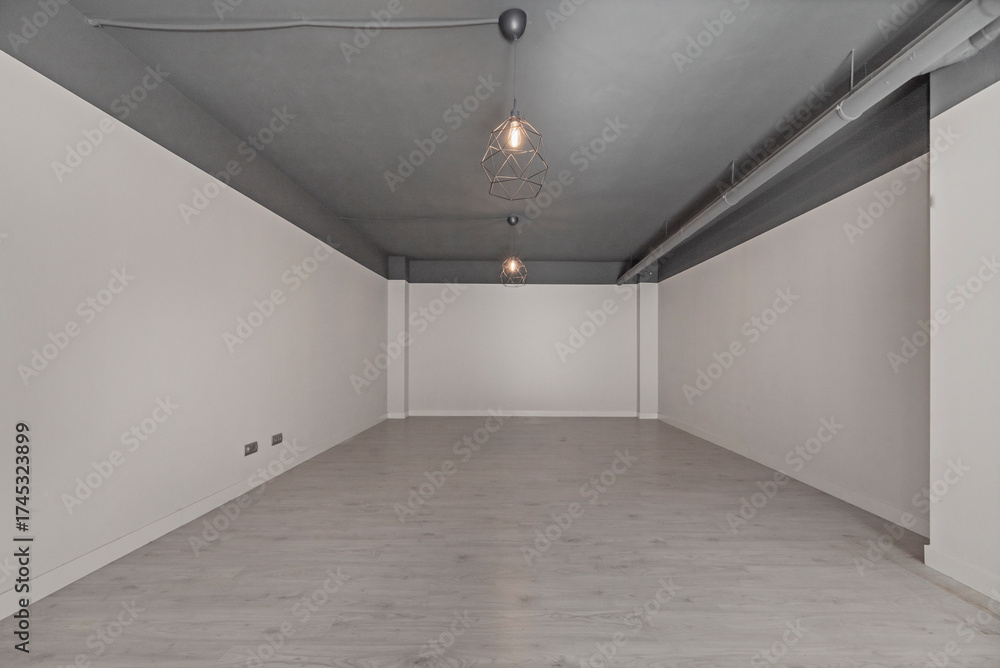 Fototapeta premium Residential basement with white-painted walls and neutral tile flooring, a blank space for custom design