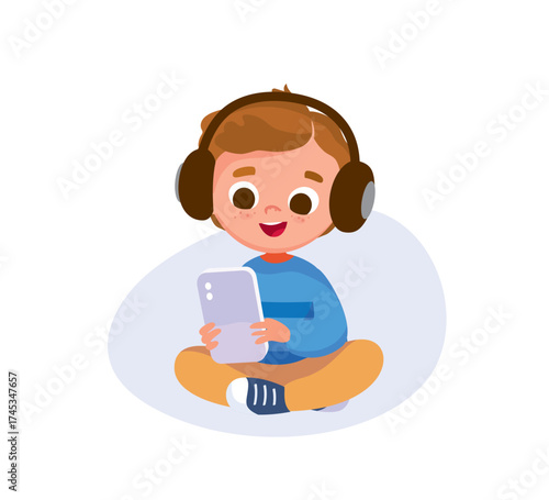 Child boy wearing gadget headset sitting in lotus pose, listening music, streaming, holding smartphone in hands. Kid searching, surfing, and watching the internet using a gadget. Child browsing data.