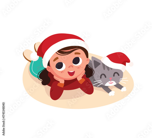 A little girl in a Christmas hat is lying next to her cat, dreaming of Christmas and New Year's celebrations. Dreams of the coming festivities. 