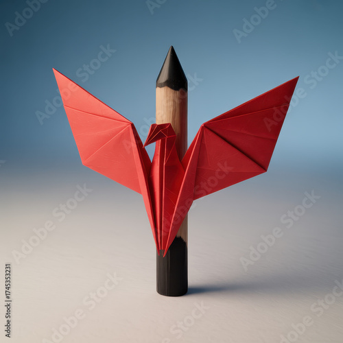 Red origami bird with open wings balanced on sharpened wooden pencil