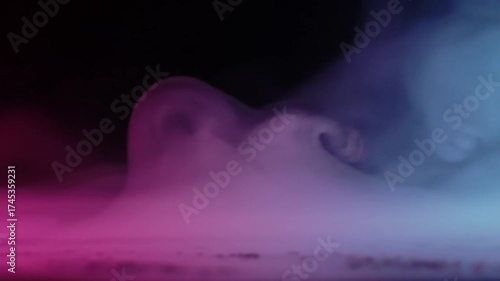 Vibrant Pink and Blue Smoke Billowing Across a Dark Stage.