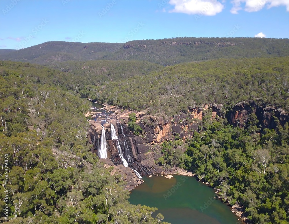Fototapeta premium Multi-tiered waterfall in a vast green wilderness