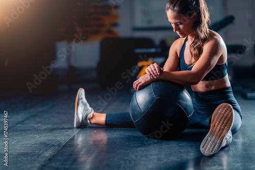 Stretching after a gym workout, a woman promotes muscle recovery and flexibility. Structured stretches reduce soreness, enhancing comfort and long term fitness.