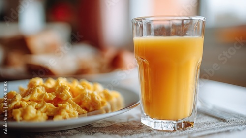 Breakfast with Scrambled Eggs and Fresh Orange Juice in Glass