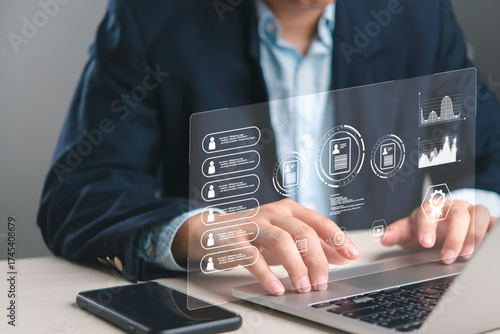 Businessman analyzing employee performance on HR management software dashboard. Reviewing digital CVs, personnel data for corporate development. Technology for modern recruitment strategy.