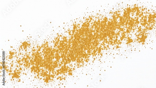 A scattered line of golden particles on a white background creating a textured abstract design element