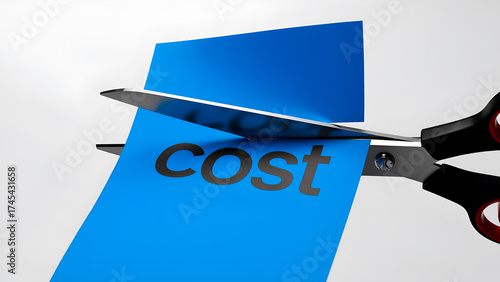 Scissors cutting a blue paper with the word cost printed on it, symbolizing expense reduction and budget management strategies