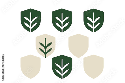 Seamless repeating pattern of green and beige shields with stylized botanical leaf motifs