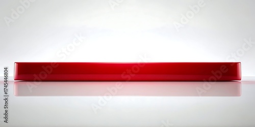 Bright red rectangular container or box with a glossy finish on a reflective surface