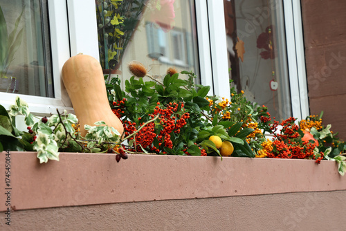 Autumn window decoration made of vegetables and leaves
