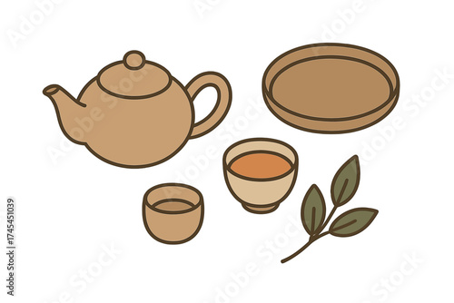 Traditional ceramic teapot and cups set with green tea leaves