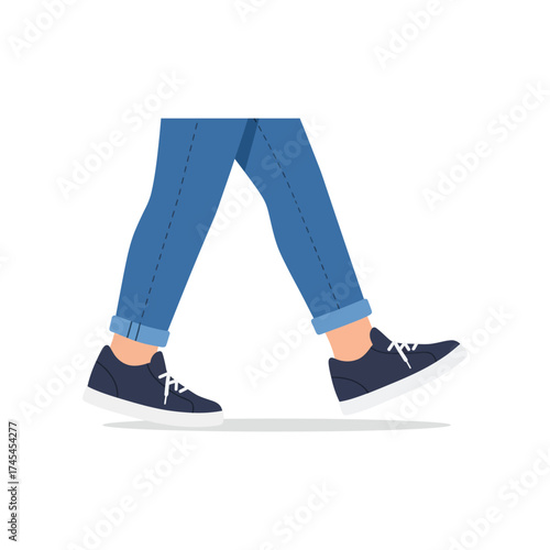 Close up view of a person s legs and feet wearing blue jeans and dark sneakers walking on a white background