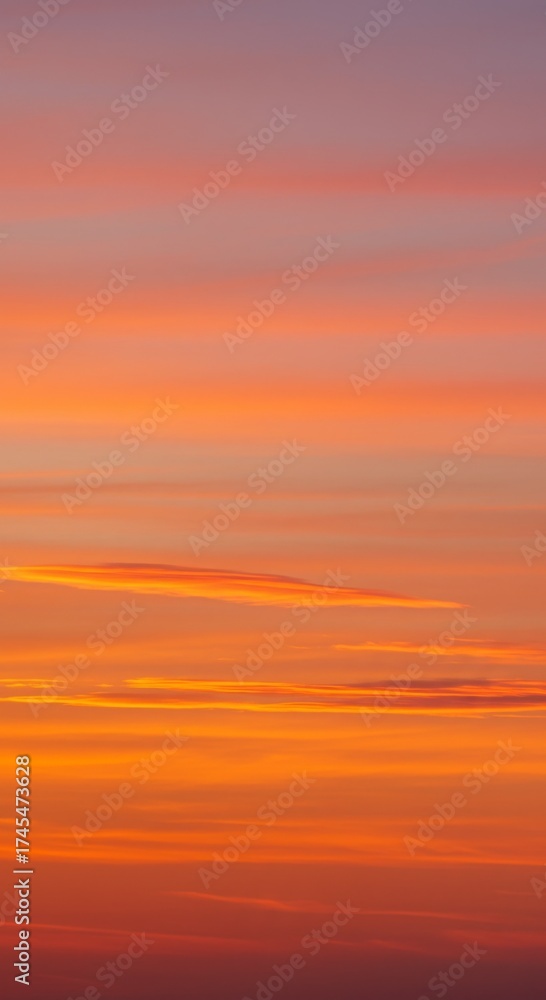 Fototapeta premium Striking Sunset Sky with Vibrant Orange Yellow and Purple Clouds in Atmospheric Landscape