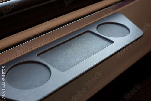 Close up of phone charging panel in train, featuring wireless charging capabilities for passengers. Modern and convenient solution for keeping devices powered during travel on public transport