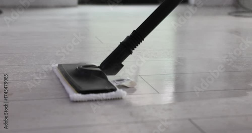 Wallpaper Mural Housewife moves steam mop slowly across tiled floor carefully cleaning away visible dirt. Powerful steam jet removes sticky dirt from surface of floor Torontodigital.ca