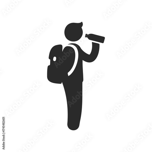 Silhouette of person hiking with backpack and drinking water