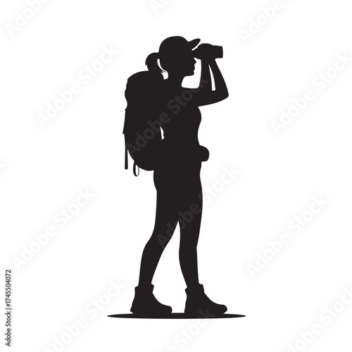 Woman hiker with backpack looking through binoculars silhouette