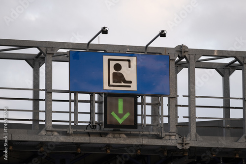 Toll gate sign with green arrow on highway