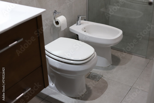 Obraz na plátně Bathroom with sink, toilet, bidet and shower screen