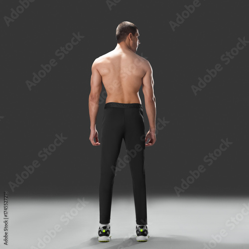 Fit young man wearing sportswear standing in studio