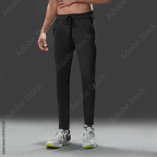 Fit young man wearing sportswear standing in studio