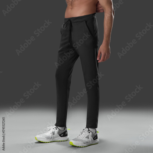 Fit young man wearing sportswear standing in studio