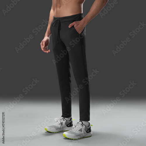 Fit young man wearing sportswear standing in studio
