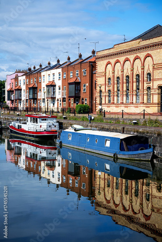 Fotografie Bright boats and old buildings reflected in water