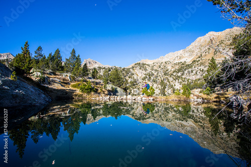 Wallpaper Mural Young hiker woman in autumn in Aiguestortes and Sant Maurici National Park, Spain Torontodigital.ca