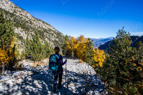 Wallpaper Mural Young hiker woman in autumn in Aiguestortes and Sant Maurici National Park, Spain Torontodigital.ca