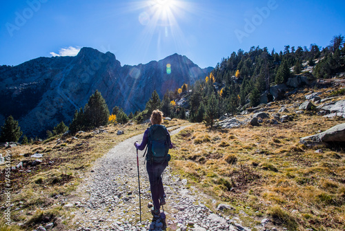 Wallpaper Mural Young hiker woman in autumn in Aiguestortes and Sant Maurici National Park, Spain Torontodigital.ca