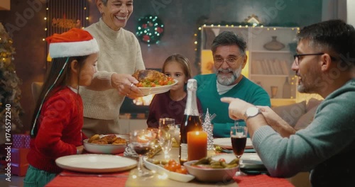 Granddaughter helping grandmother serve Christmas dinner. Heartwarming family holiday moment of love, joy, and multigenerational togetherness at home.
