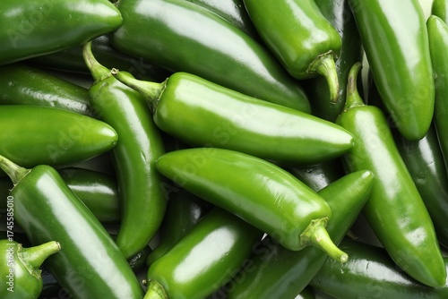 Fotografie Fresh green jalapeno peppers as background, top view