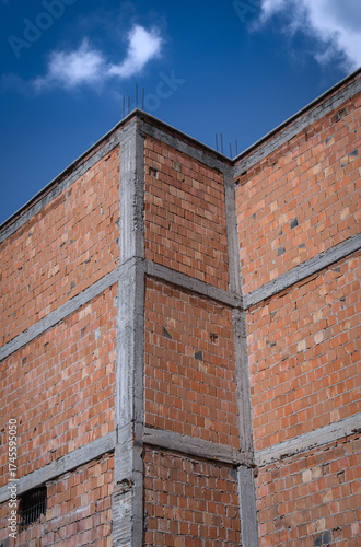 unplastered and unpainted brick building wall.