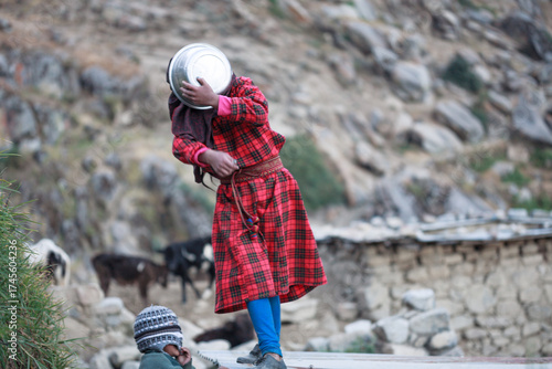 Children from the village of Tupe play and cover their faces, Yauyos, Peru