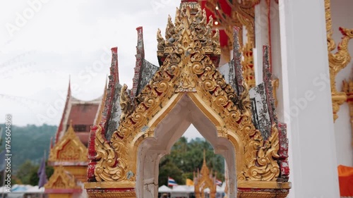 Golden architectural details of wat chalong buddhist temple, representing traditional Thai cultural heritage in Phuket.