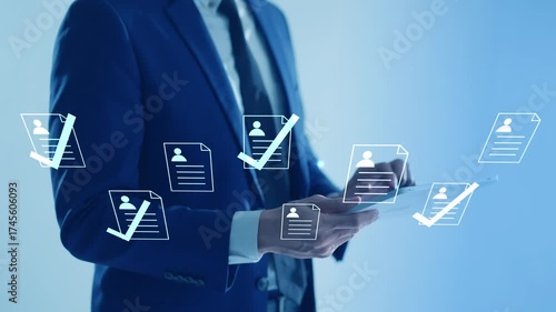 Businessman using a digital tablet for human resources management, reviewing employee documents for approval.