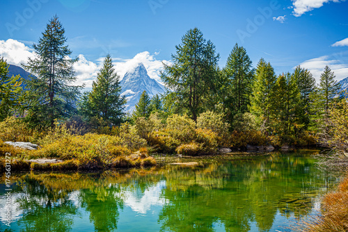 Beautiful clear green mountain lake with the reflection of the Matterhorn mountain in the water