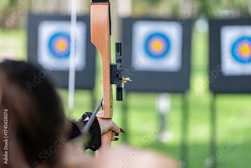 Archery Focus: Close-up of Archer Aiming Recurve Bow at Target on the Range