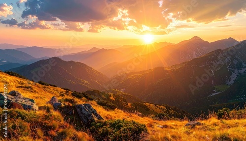 Fototapeta Naklejka Na Ścianę i Meble -  Golden sunset bathes mountain ranges, illuminating valleys with warm light and colors