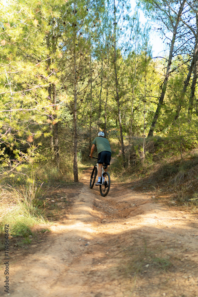 Naklejka premium young man riding a bike