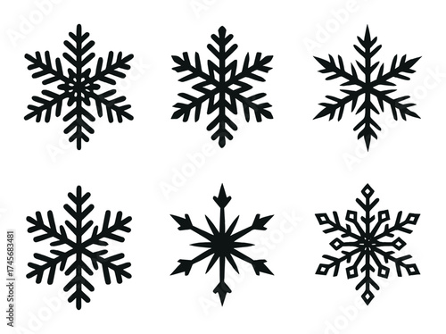 Six intricate black snowflakes on dark brown background