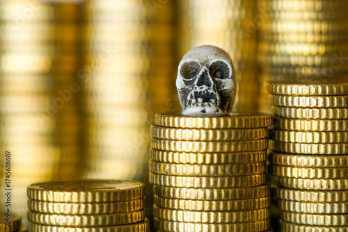 Skull on stack of gold coins symbolizing death, greed, corruption, financial danger, or mortality