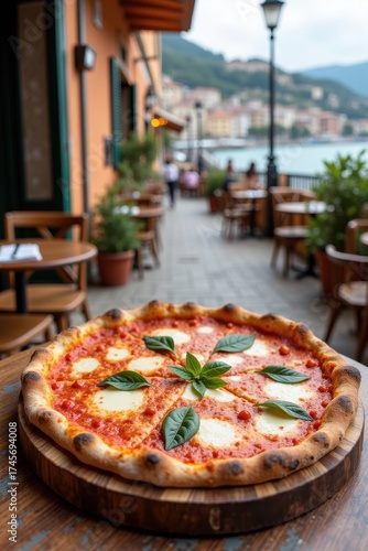 A perfect Neapolitan pizza rests on a rustic table at an outdoor cafe in Naples. The background shows a charming Italian street with a view of the sea in the distance