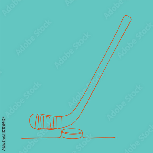 Close-up of a hockey stick and puck on an ice rink , ready for gameplay in a winter sports setting