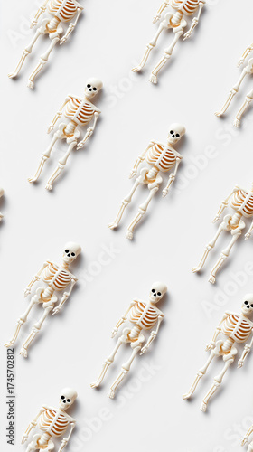 Pattern of small toy skeletons on white background for Halloween Decor.